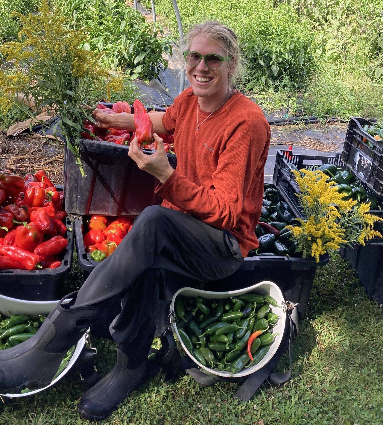 Isak Davis posing with farm produce